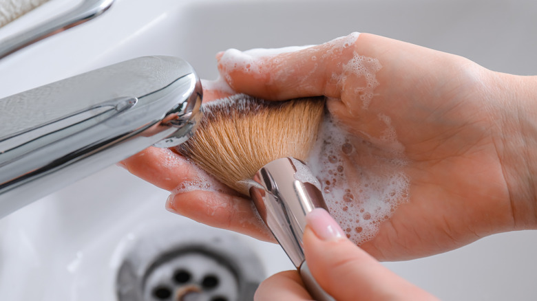 Person washing brush 