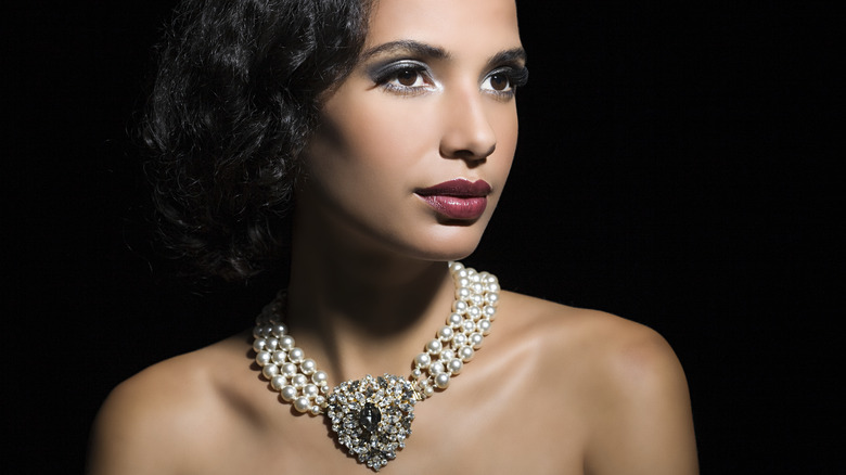 Elegant woman wearing expensive necklace