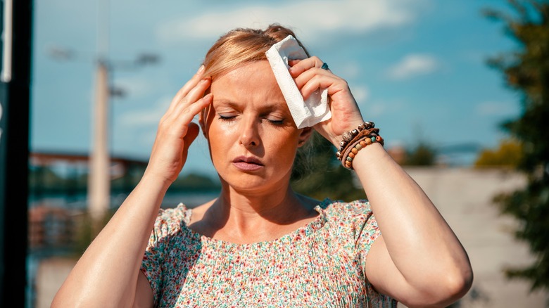 Woman on a walk sweating.