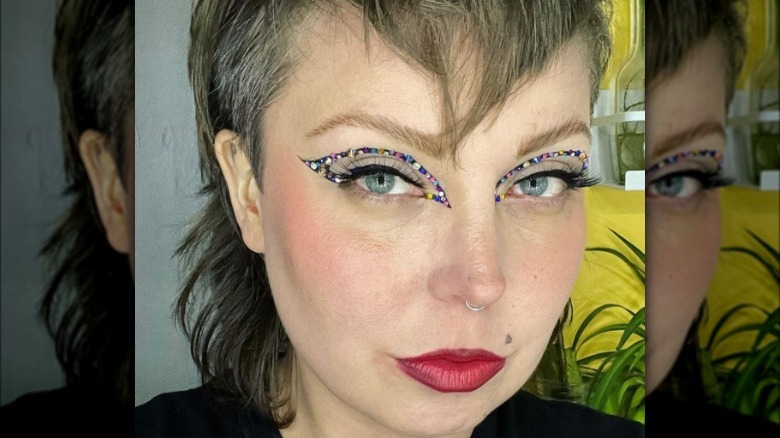 A woman with colorful bejeweled eyeliner