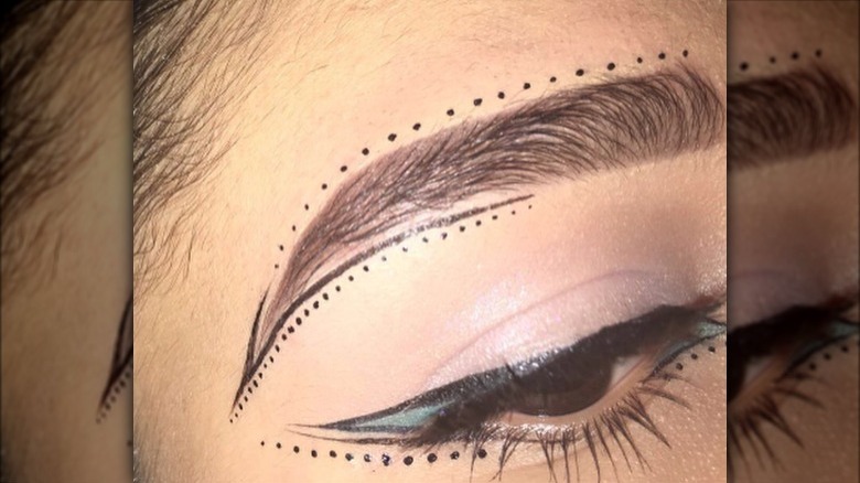 A woman with dotted eyeliner