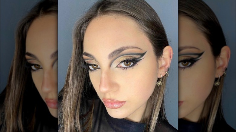 A woman with dramatic fox eye makeup