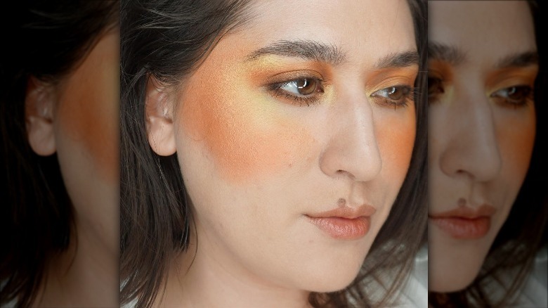 Woman orange yellow blush eyeshadow blend