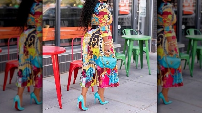 Woman in patterned pleated dress 