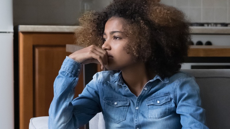 sad female sitting on couch