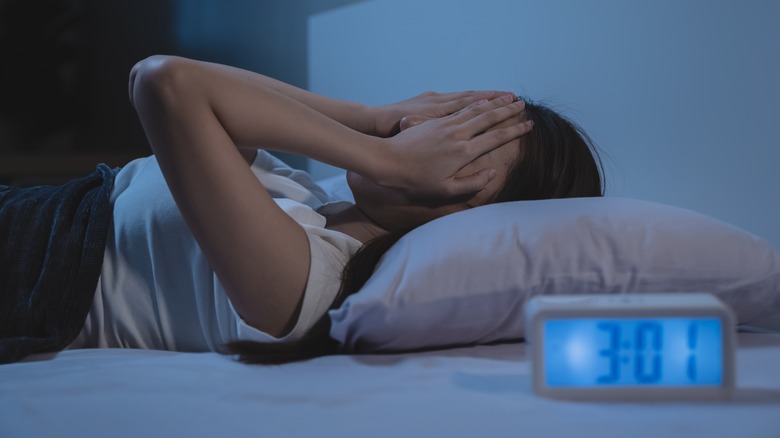 Woman having nightmare in bed