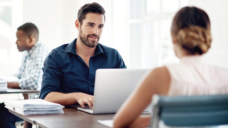 Man beams at coworker