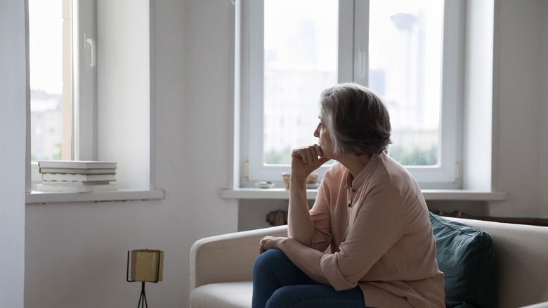 Woman looking out of the window, sadly