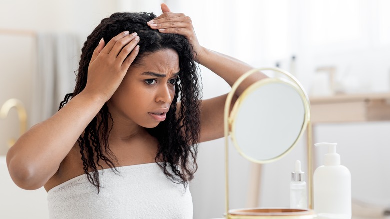 Girl checking her hair for baldness