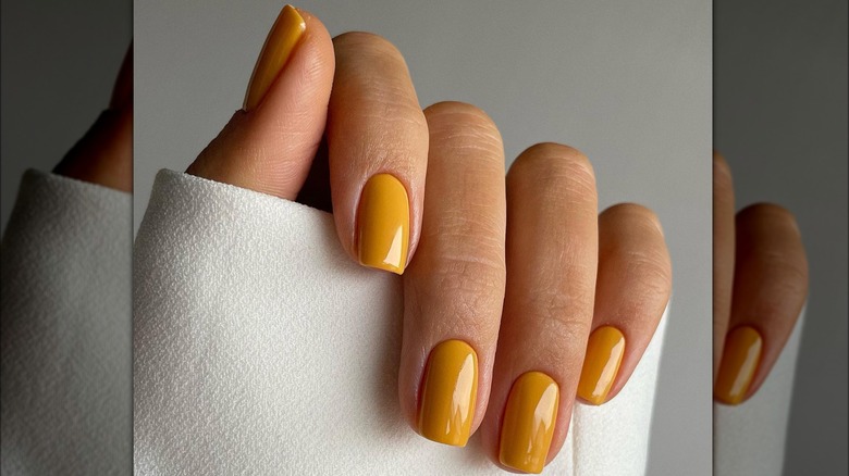 Mustard yellow nail polish white sleeve