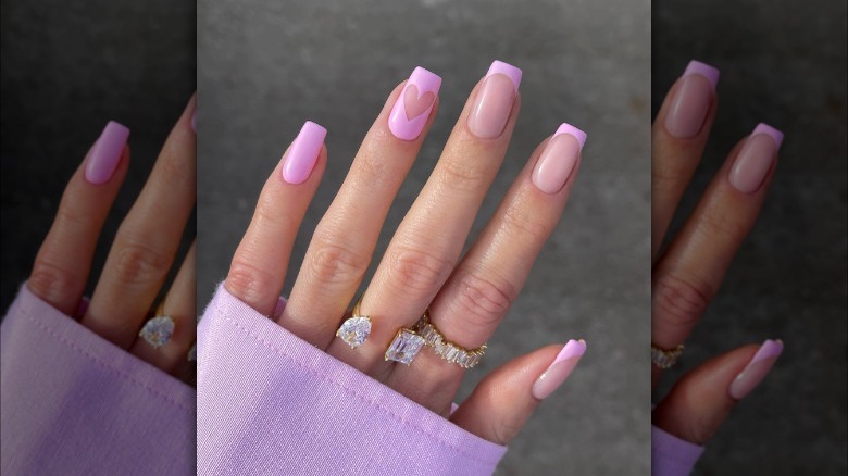 Pale pink French tips with heart accent nail
