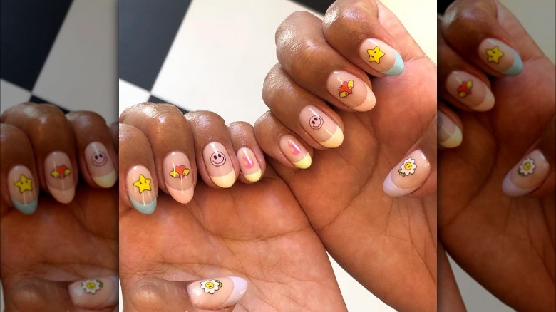 Pastel French manicure with cartoonish nail stickers