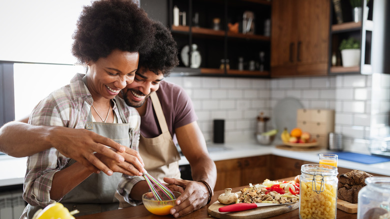 happy couple cooking