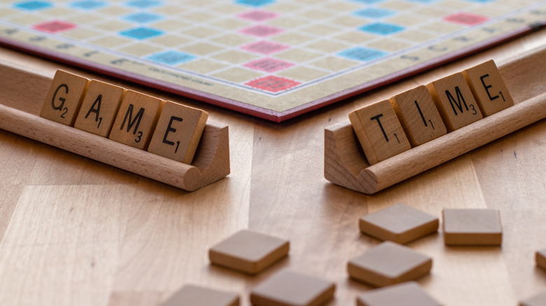 Scrabble tiles spelling "game time"