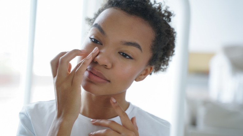 Woman applying eye cream