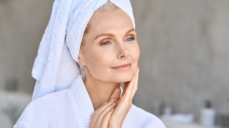 woman looking content touching chin 