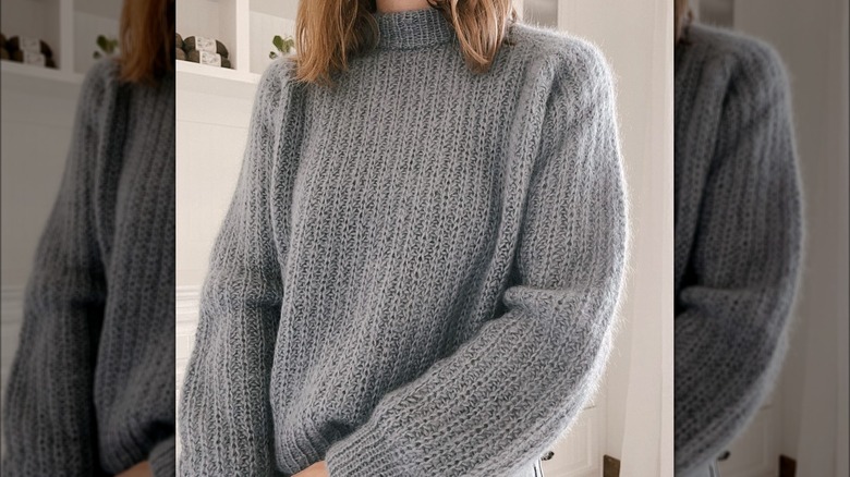 woman wearing dusty blue sweater