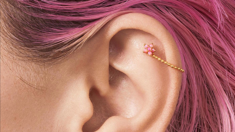 woman wearing pink helix earring