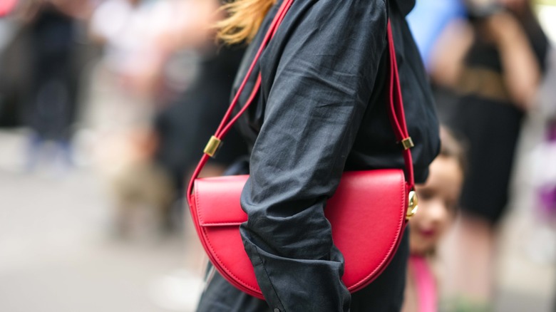 woman wearing red shoulder bag