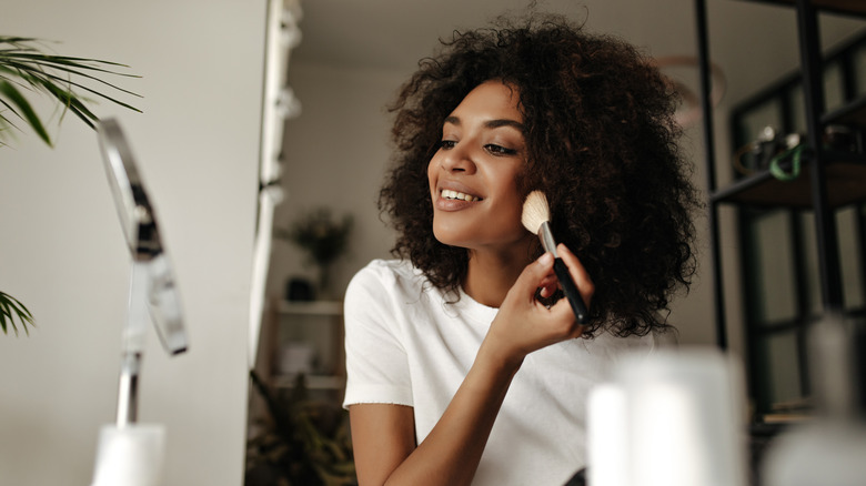 woman using makeup brush