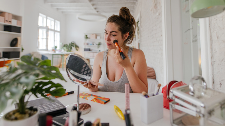 woman applying makeup