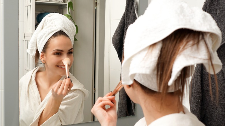 woman touching nose with brush