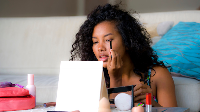 Woman applying makeup