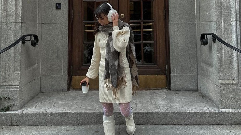 Woman wears white sweater dress 