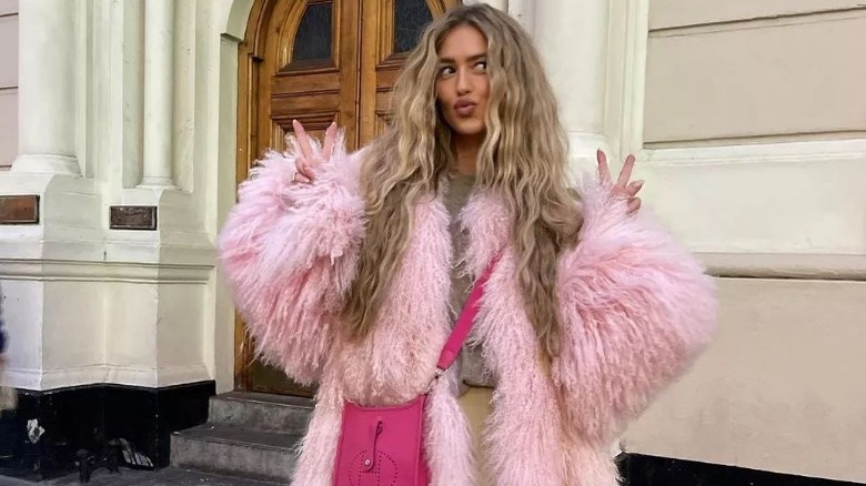 Woman models pink fur coat 