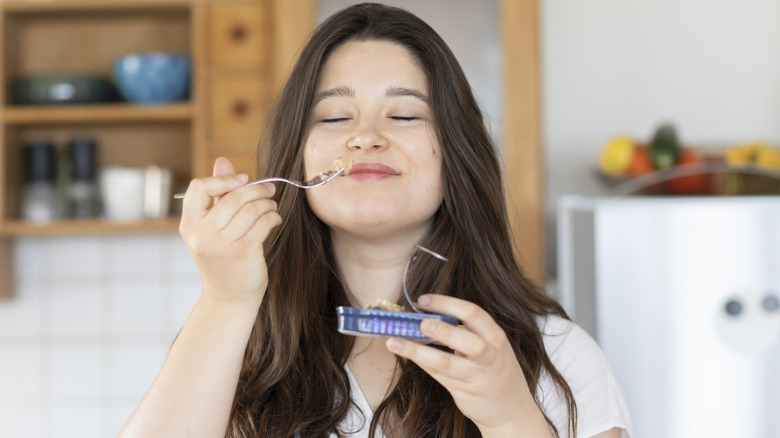 Woman eating sardines