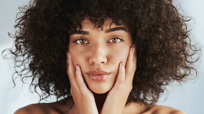 Beautiful woman touching face