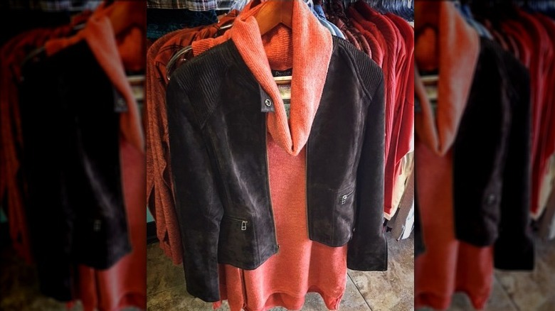 Suede jacket with zippered pockets on rack