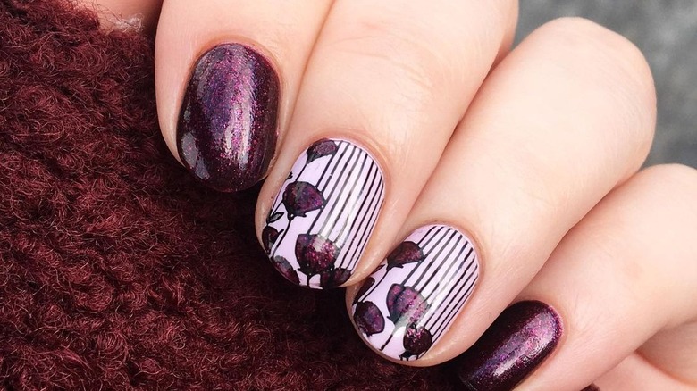 white manicure with dark purple flower/striped nail art