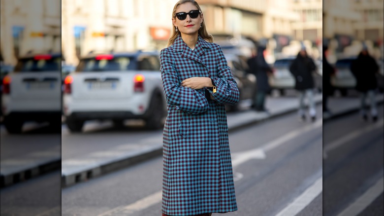 Woman wearing blue plaid trenchcoat