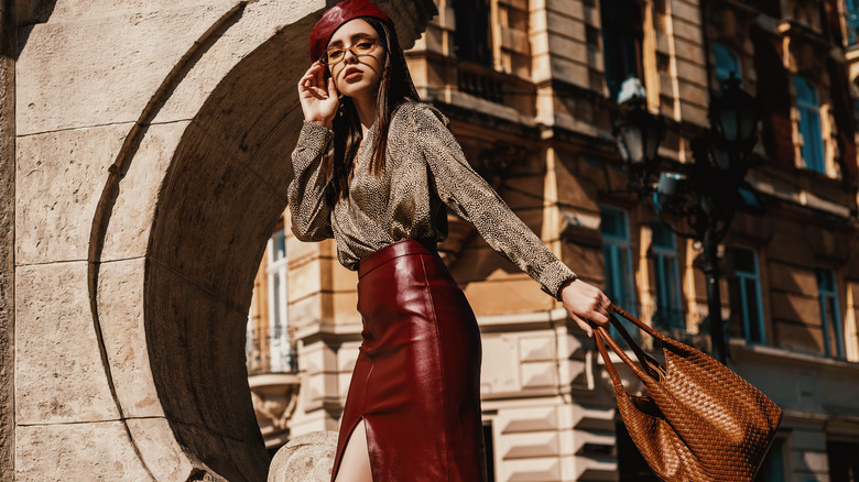 Woman wearing burgundy leather pencil skirt