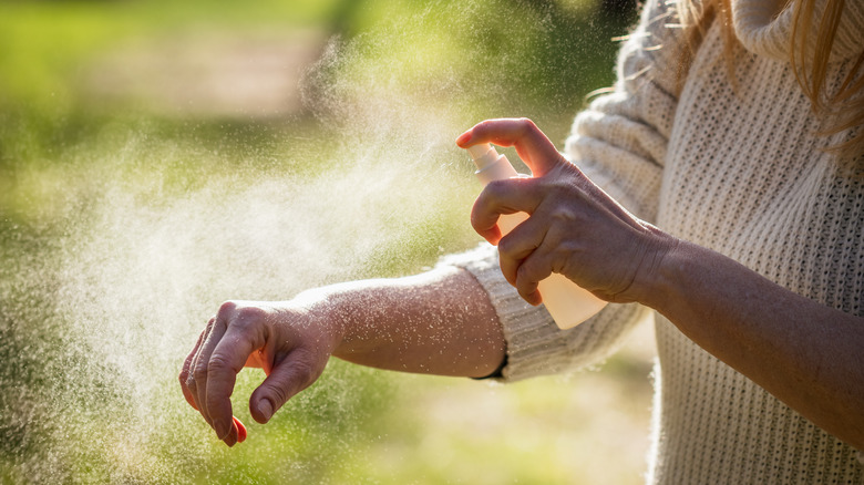 girl spraying body mist