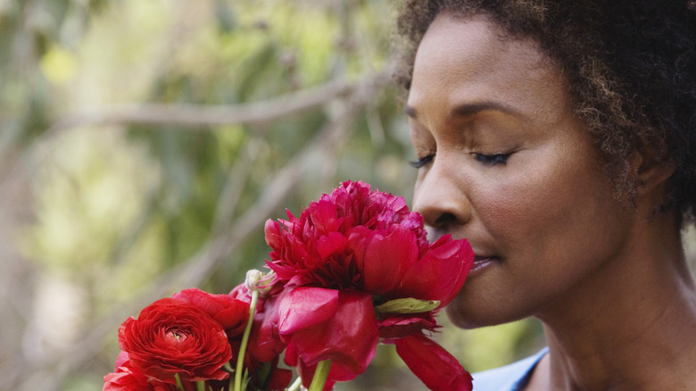 Woman smelling flowers