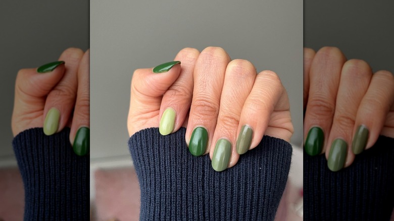 green paint chip nails and sweater