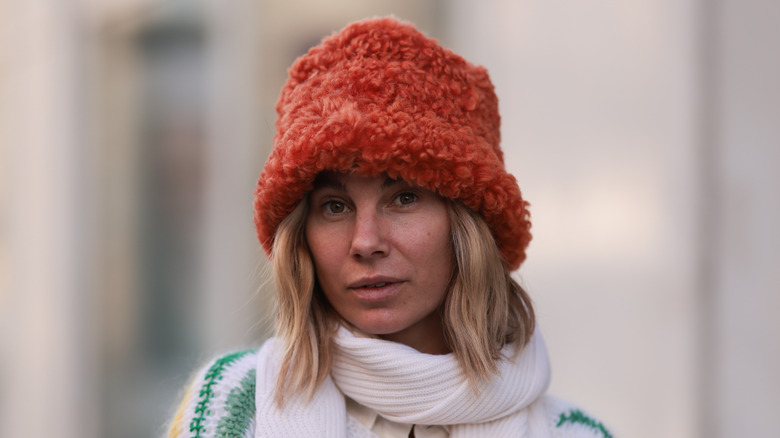 Karin Teigl wearing a fuzzy orange bucket hat
