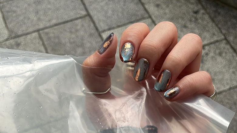 woman with shiny nails