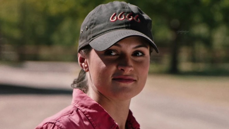 Emily (portrayed by Kathryn Kelly) wearing a pink shirt and wearing a black cap on 