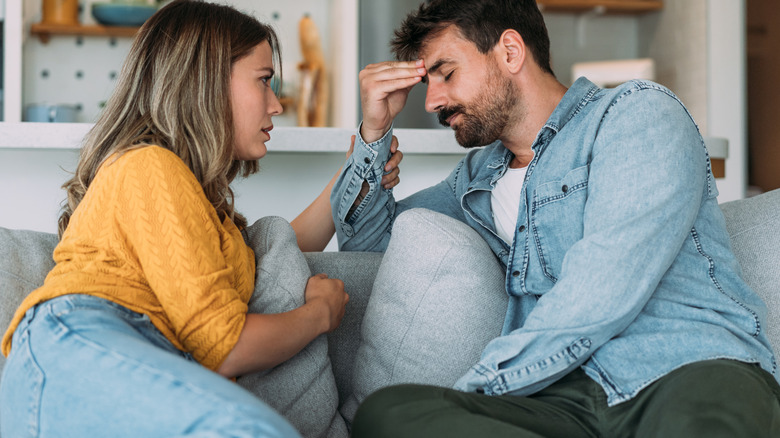 Woman, man talking on couch