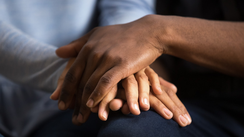 A close-up of holding hands