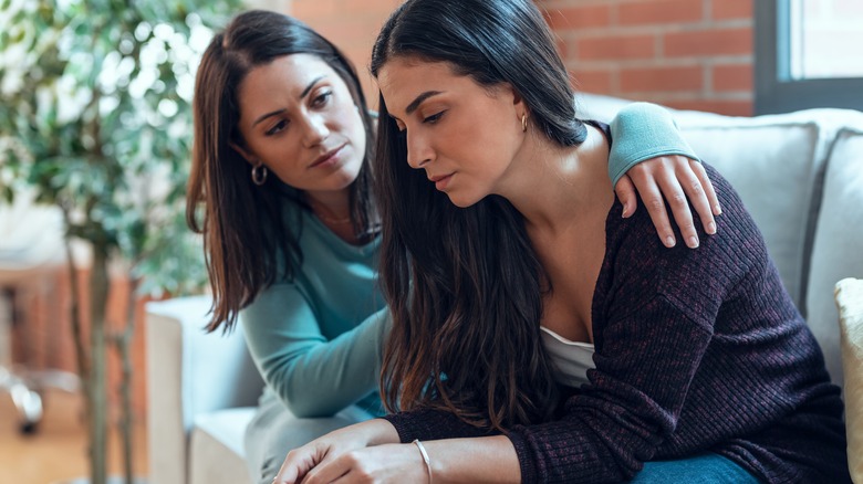 A woman comforting another woman