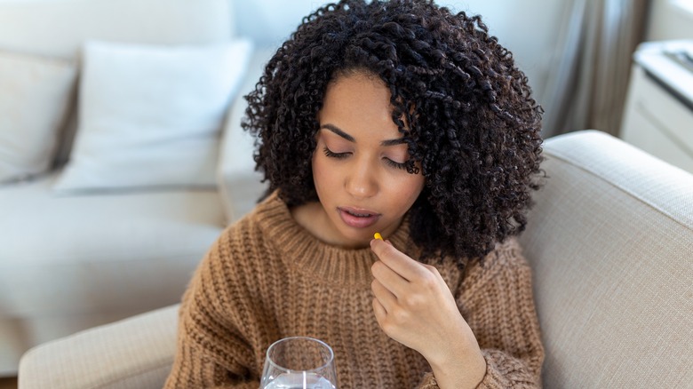 woman taking pill