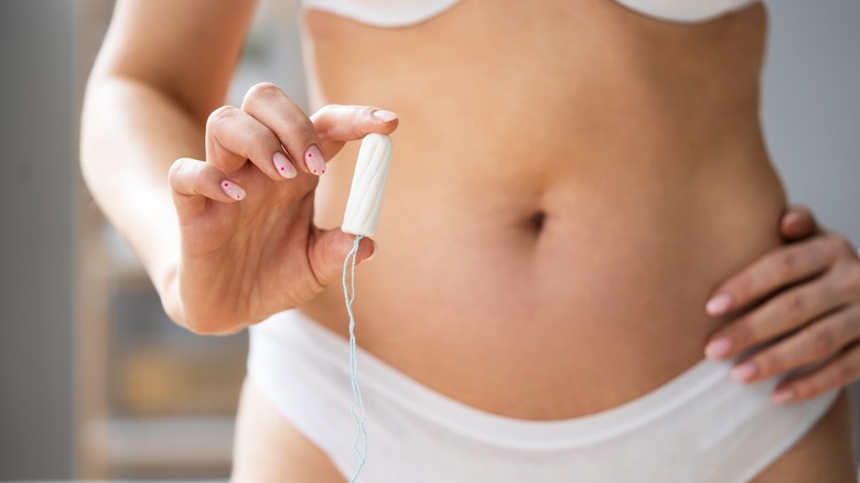 woman holding tampon 