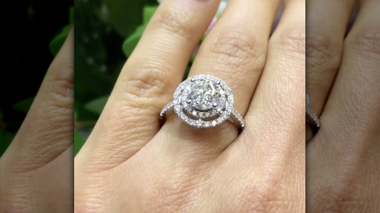 woman with round cut diamond ring