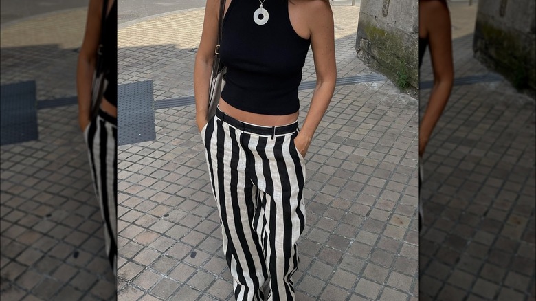 Woman wearing black-and-white striped pants