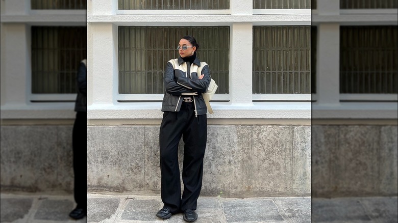 Woman wearing black trousers, jacket