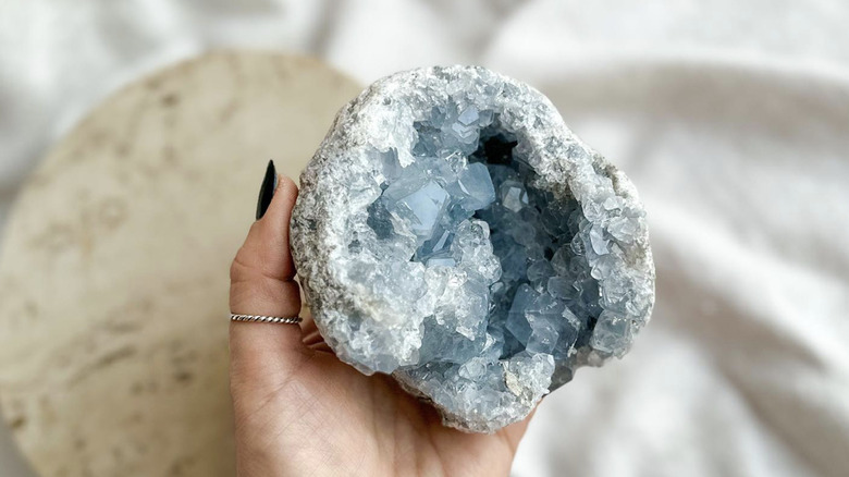 person holding celestite